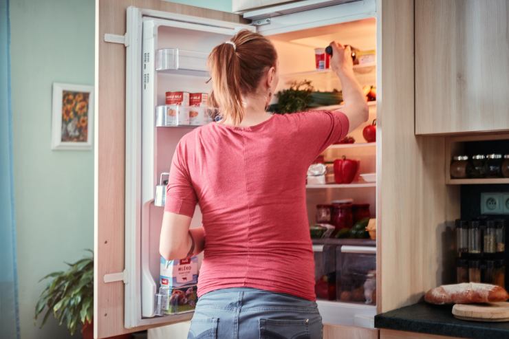 donna che prende degli alimenti dal frigorifero 